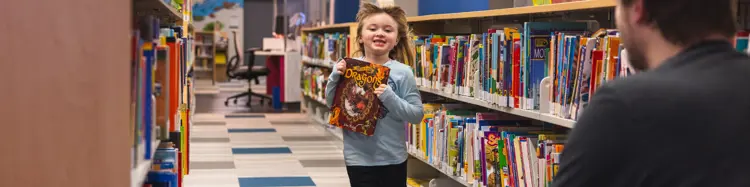 photo of a girl with a book running toward her father